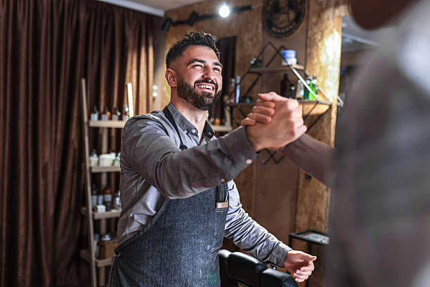 Master barber greeting a client at King's Cut Barbershop